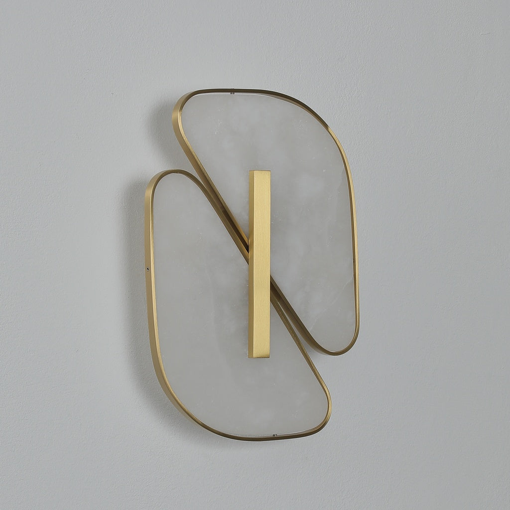 Three-quarter view of the unlit alabaster wall sconce and copper-color rims