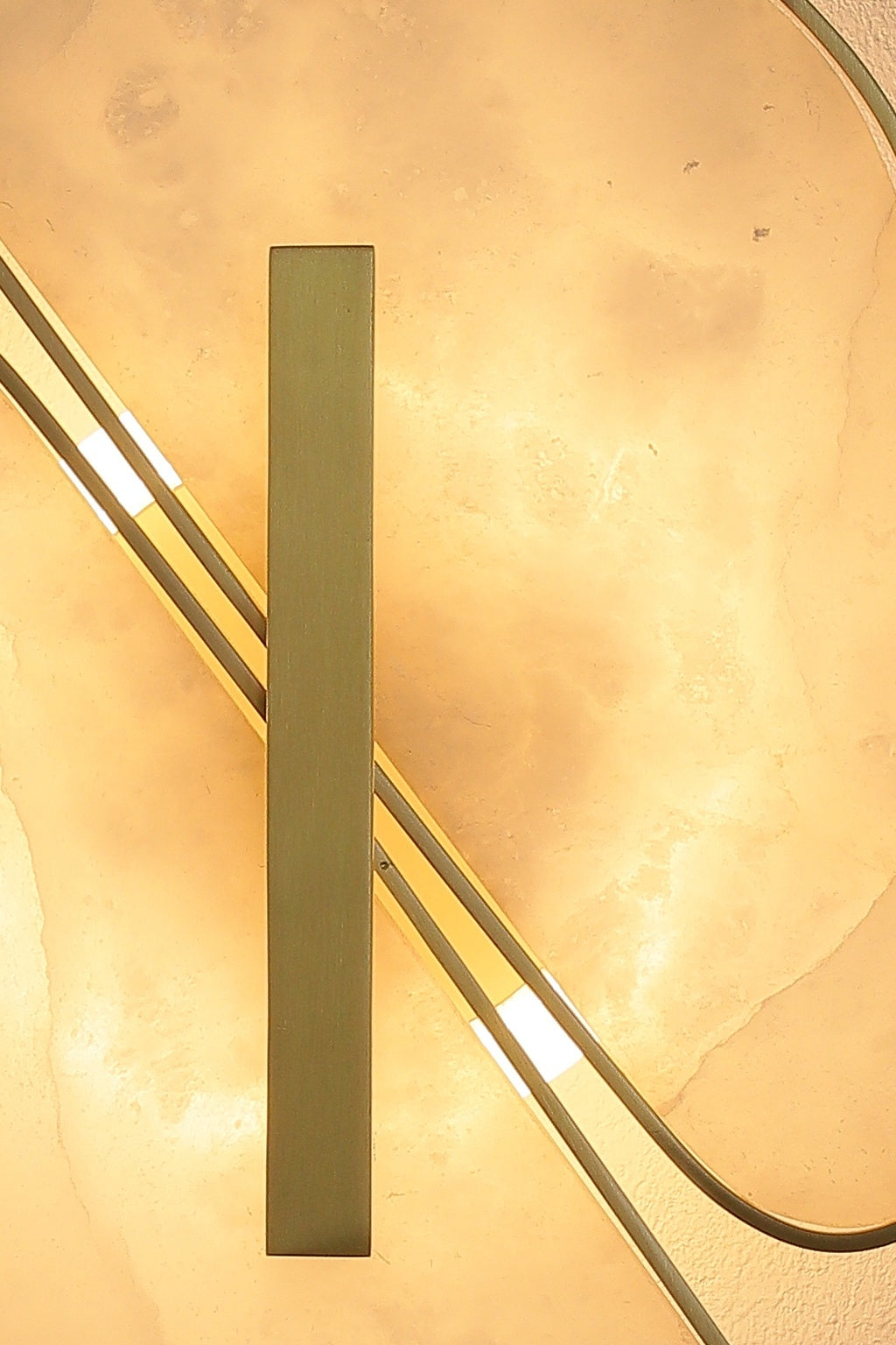 Close view of the vertical copper-color bar and illuminated alabaster join