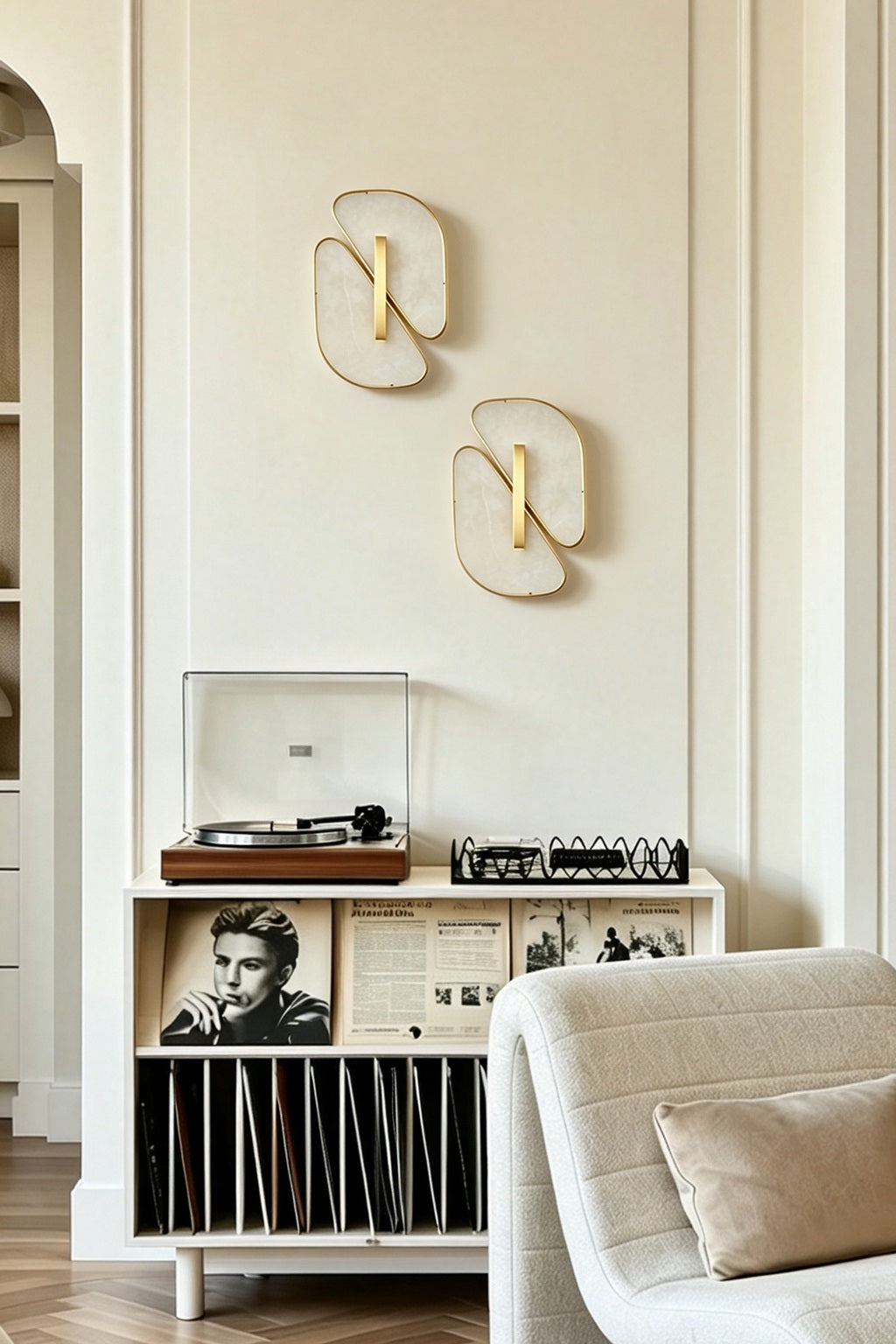 Pair of unlit alabaster sconces above a record cabinet