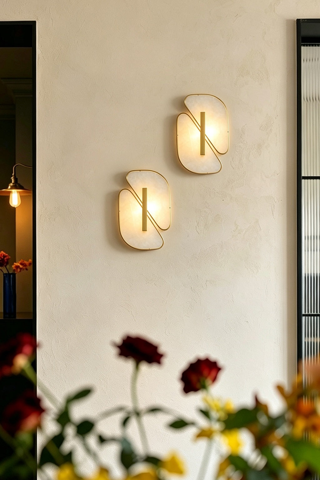 Pair of illuminated alabaster sconces between doorways