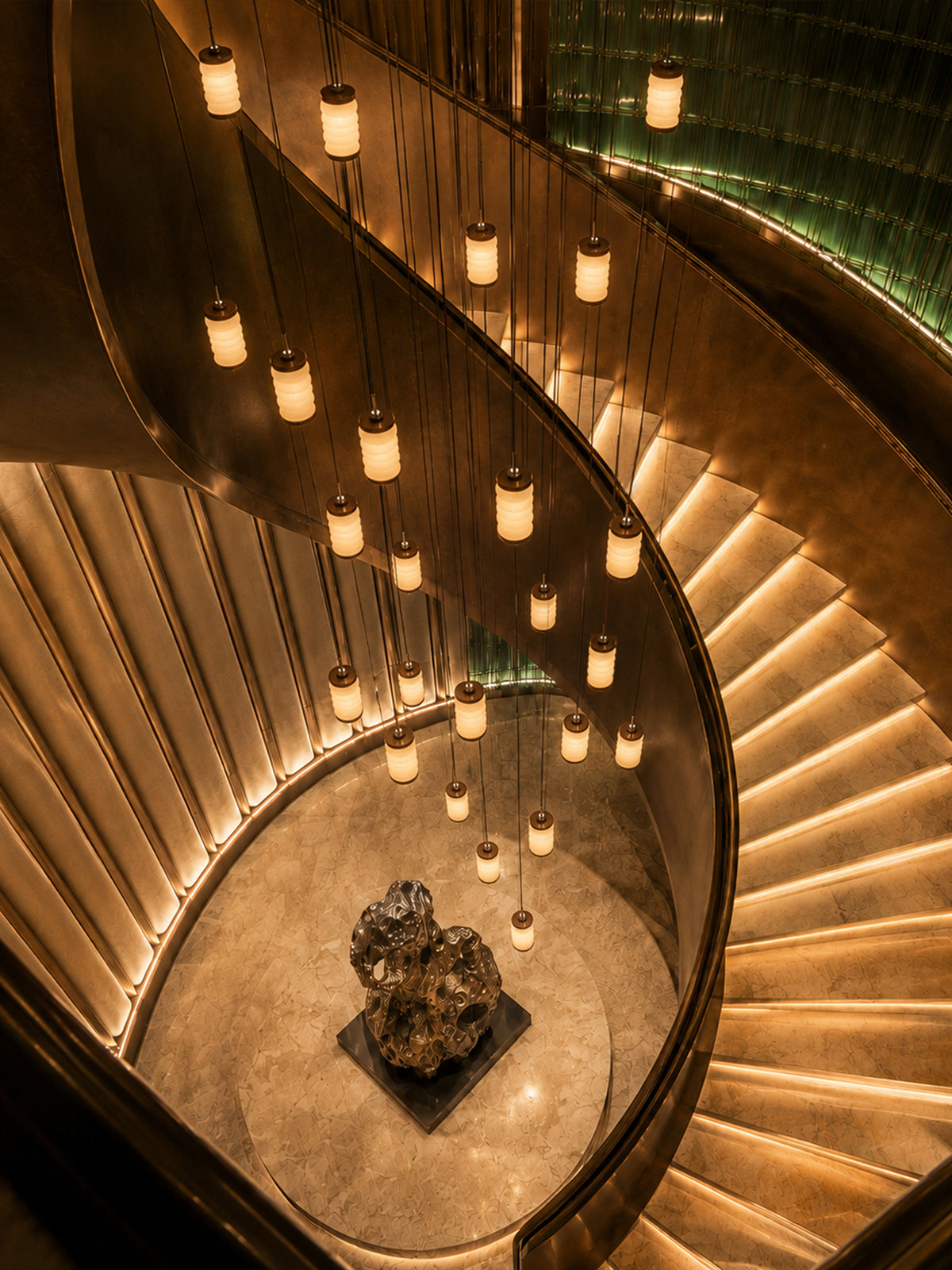 Ruvellune stone pendant cluster viewed from above the staircase, separately sold fixtures