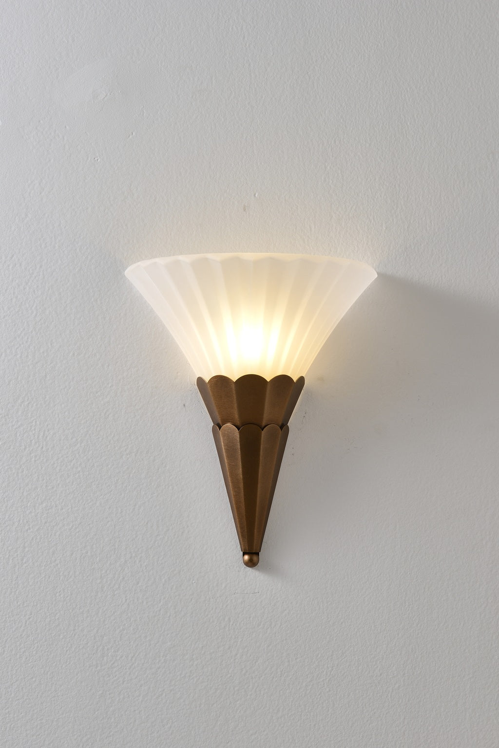 Fanelisse fluted glass wall sconce in Antique Bronze - One-tier actual front view, warm light