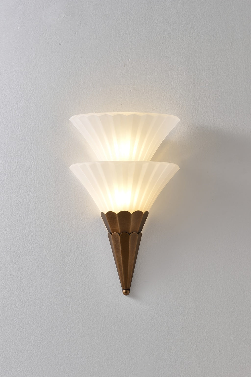 Fanelisse fluted glass wall sconce in Antique Bronze - Two-tier actual front view, warm light