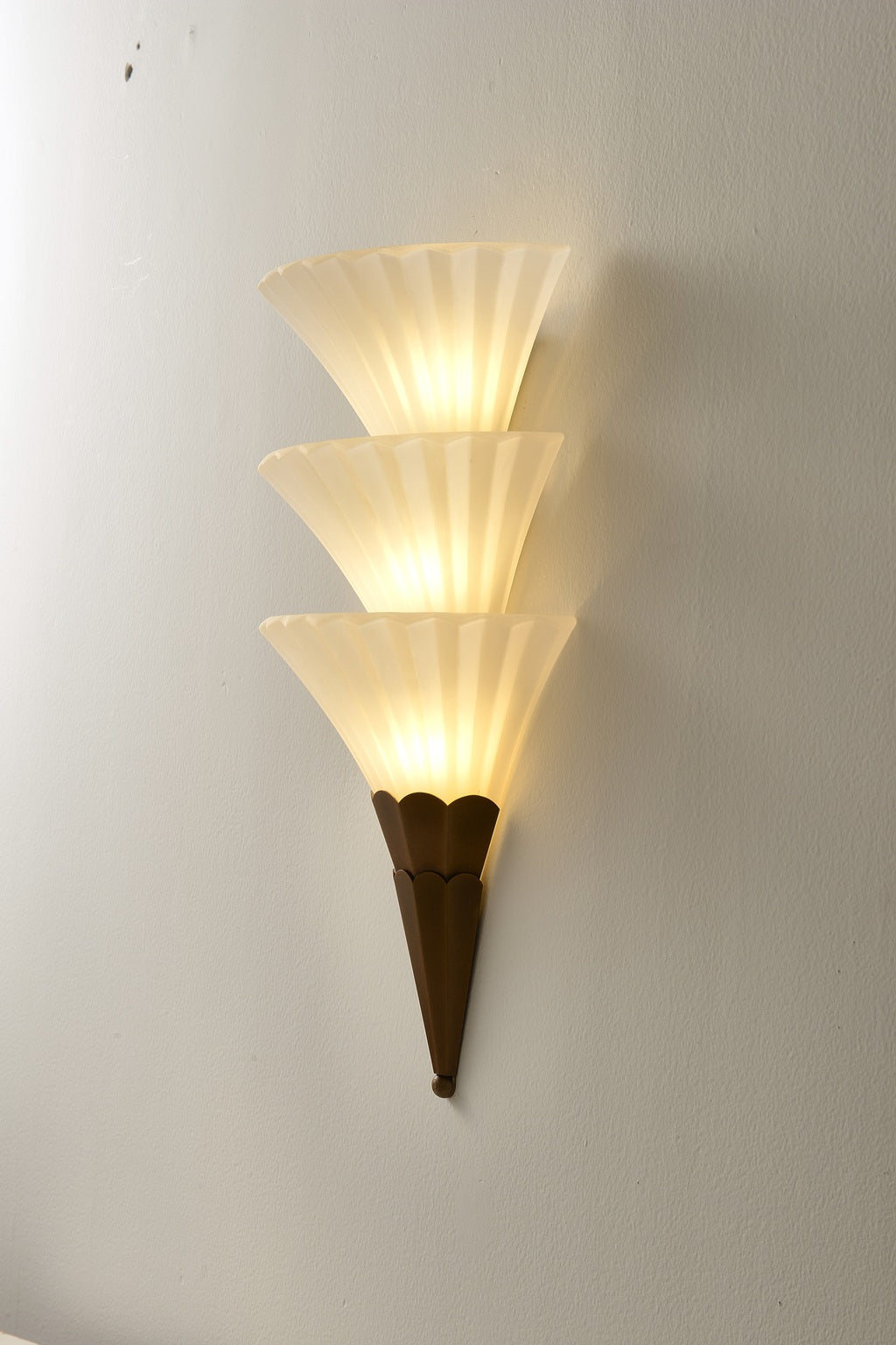 Fanelisse fluted glass wall sconce in Antique Bronze - Three-tier actual side view, warm light