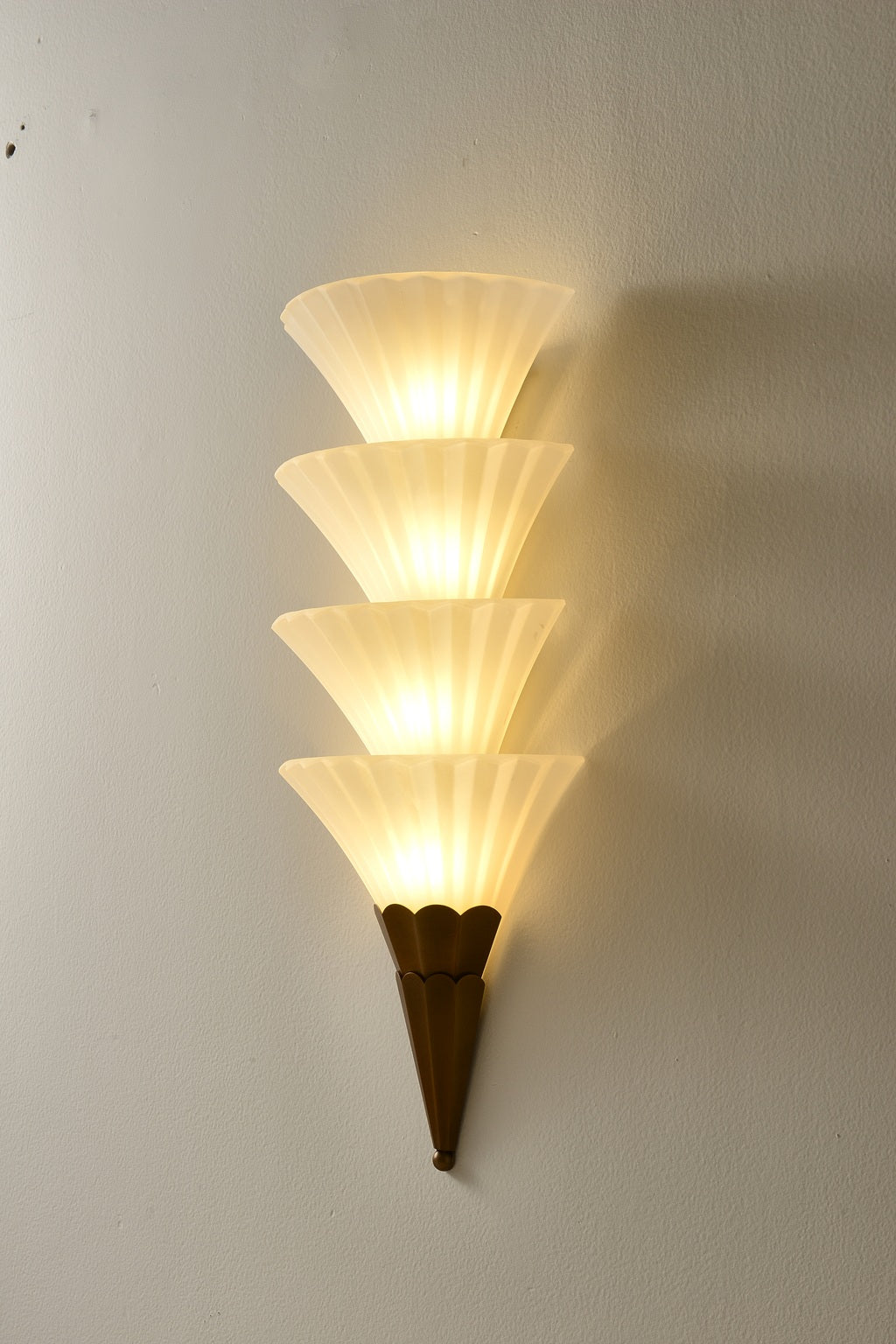 Fanelisse fluted glass wall sconce in Antique Bronze - Four-tier actual side view, warm light