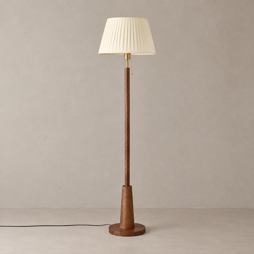 Tenvarel ash wood floor lamp with ivory pleated shade, switched off on a warm beige floor