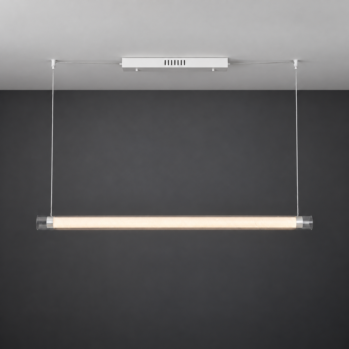 White canopy and silver tube pendant illuminated against a cleaned gray photography background