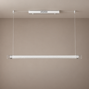 Unlit ivory tube pendant with a white canopy, silver fittings and transparent open ends, complete fixture against a taupe background