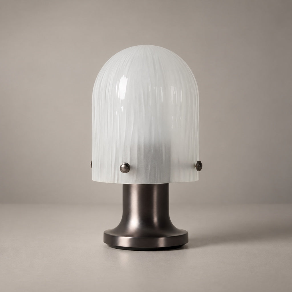 Mernoval table lamp with white streaked glass shade and dark metal base, shown unlit