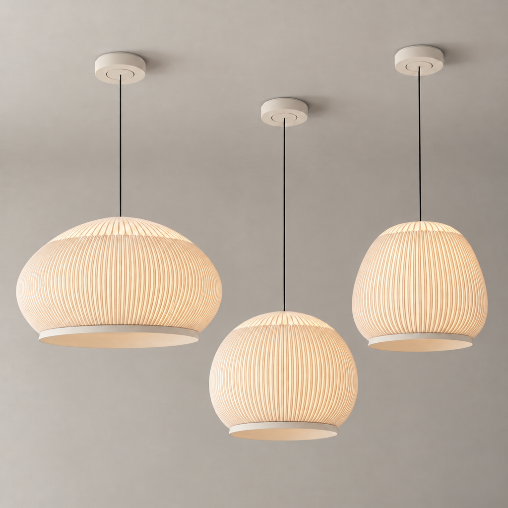 Three illuminated ribbed textile pendant silhouettes displayed with a male model in a warm modern interior