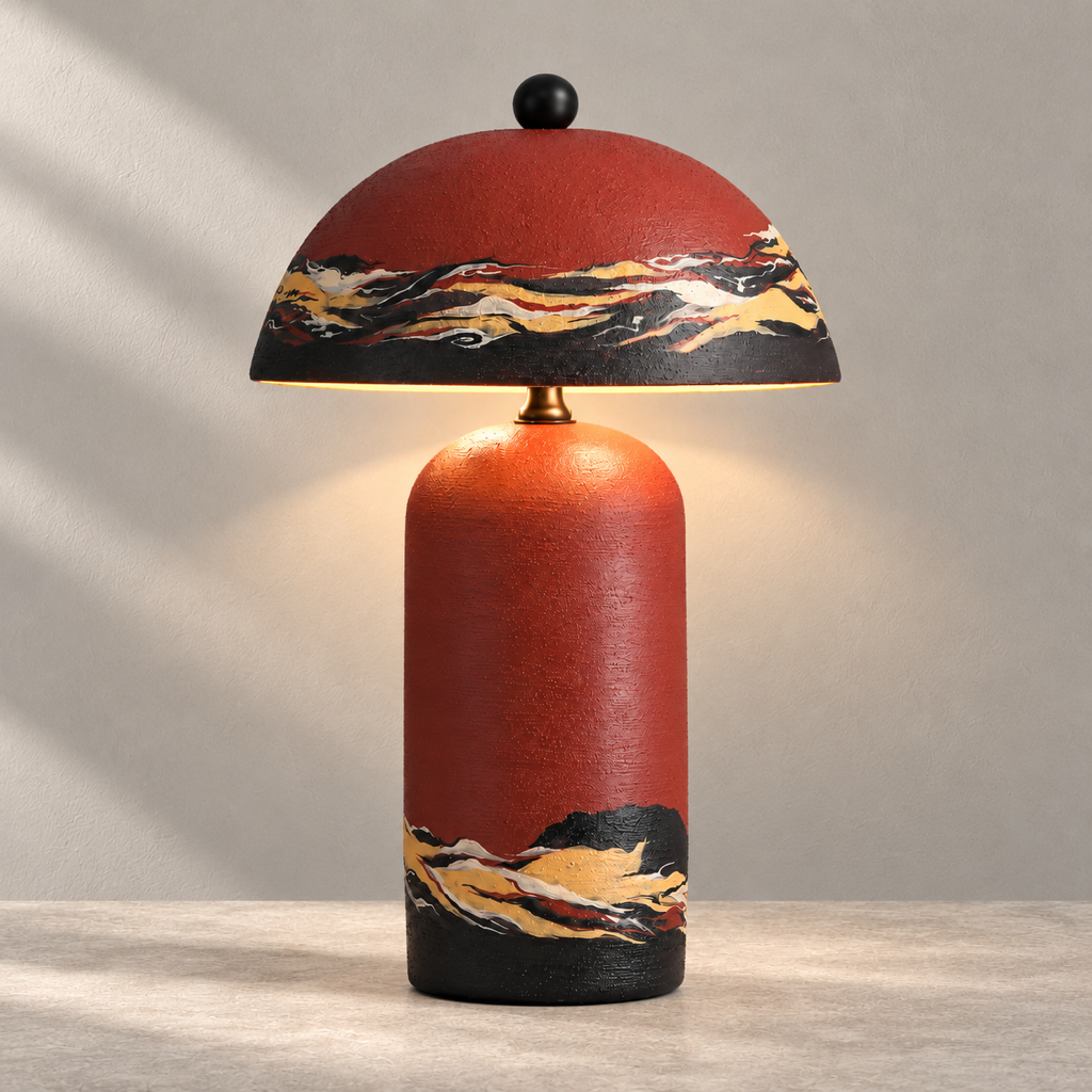 Teravelle Sunset Red hand-painted ceramic table lamp glowing on a warm stone surface