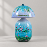 Lotavelle Blue Water Lily Ceramic Table Lamp with blue finial, switched off against a warm beige background