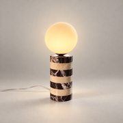 Charade Marble Globe Table Lamp on a warm greige background; Brown white striped small globe table lamp