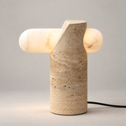 VIA Travertine LED Table Lamp on a warm greige background; White alabaster horizontal bar on beige cylinder