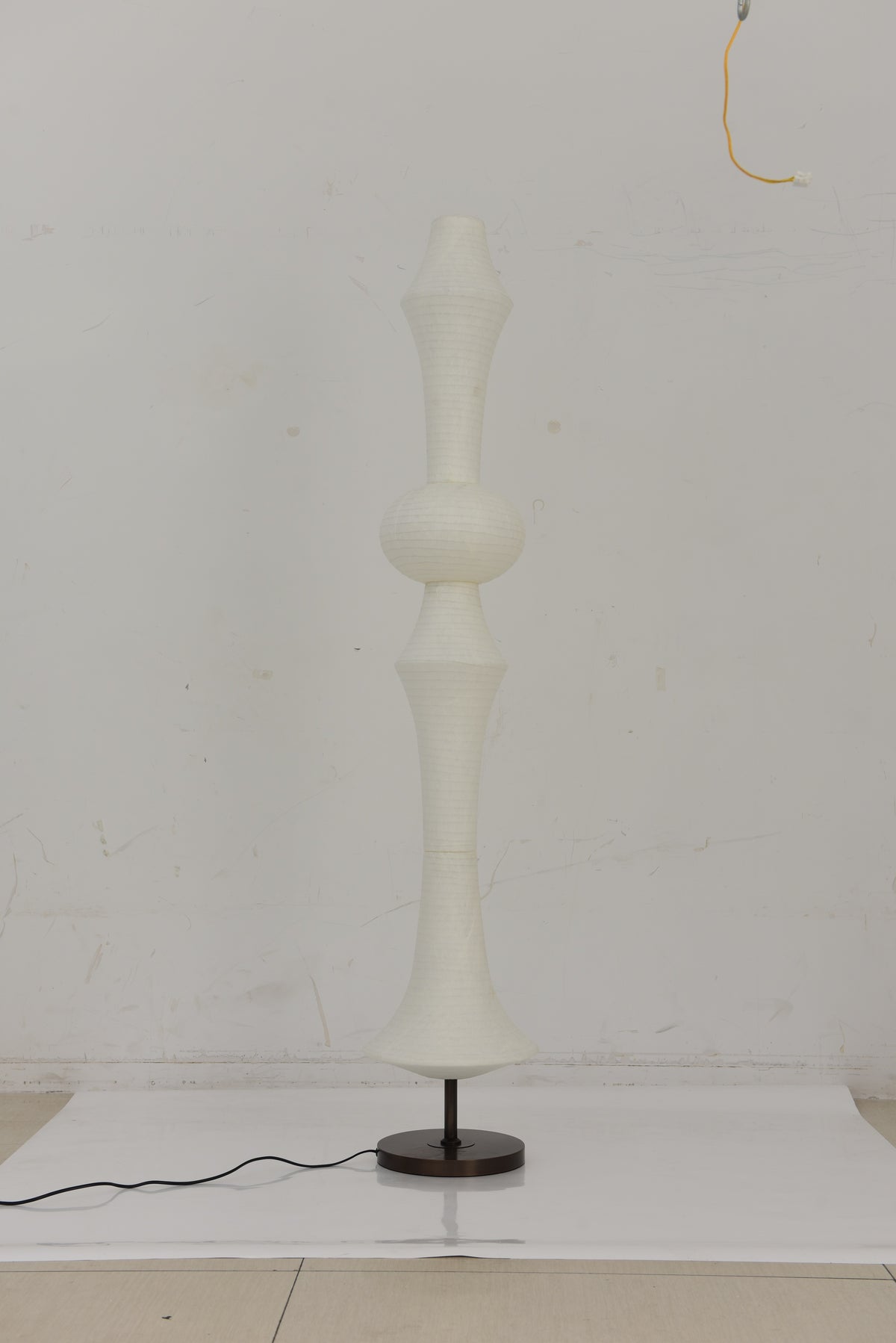 ARDEN LUME Original photograph of the Orlithane silk floor lamp Design A switched off, showing its white silk shade, short support and black round base.