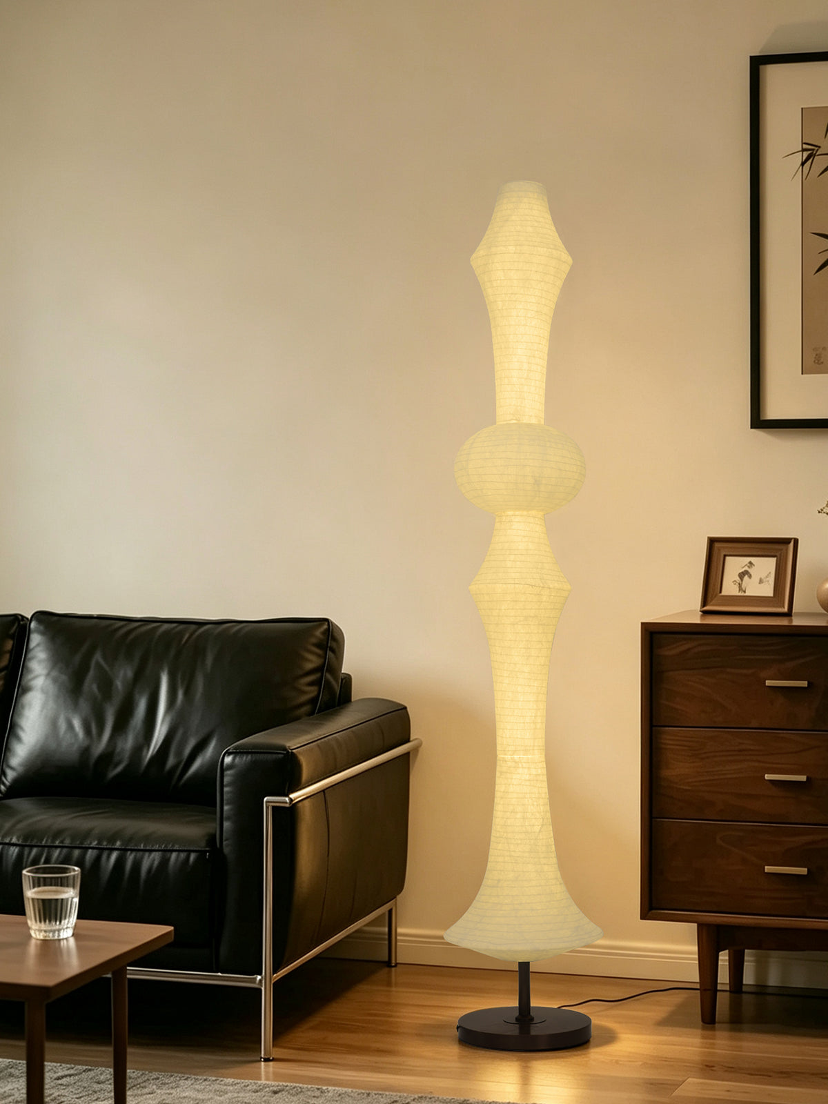 ARDEN LUME Orlithane silk floor lamp Design A switched on beside a black leather chair and walnut cabinet.