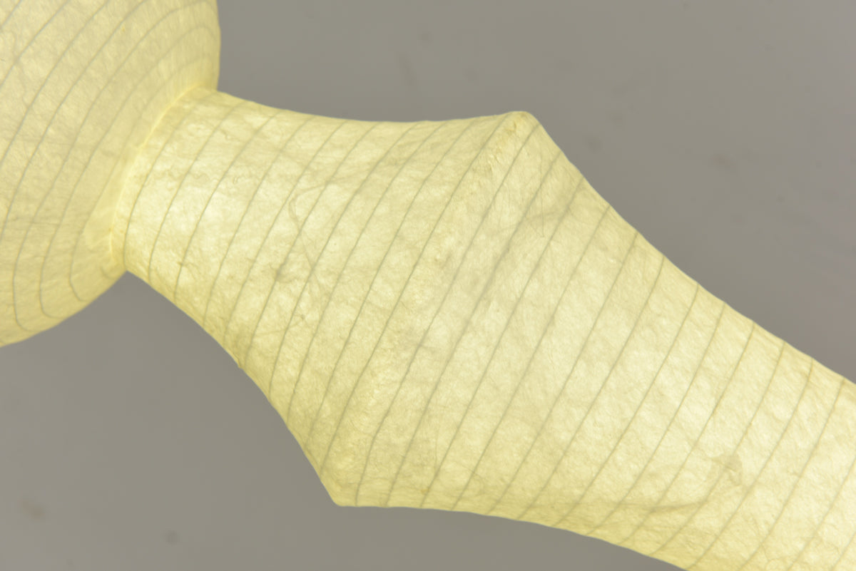 Actual close-up of illuminated Orlithane mulberry silk fabric across the angular shade section and narrow waist.