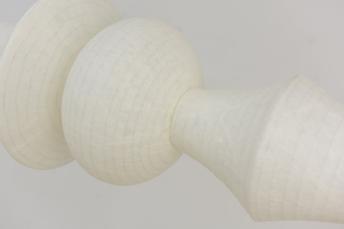 Actual unlit close-up of Orlithane mulberry silk fabric around the globe, flared rim and angular shade transition.