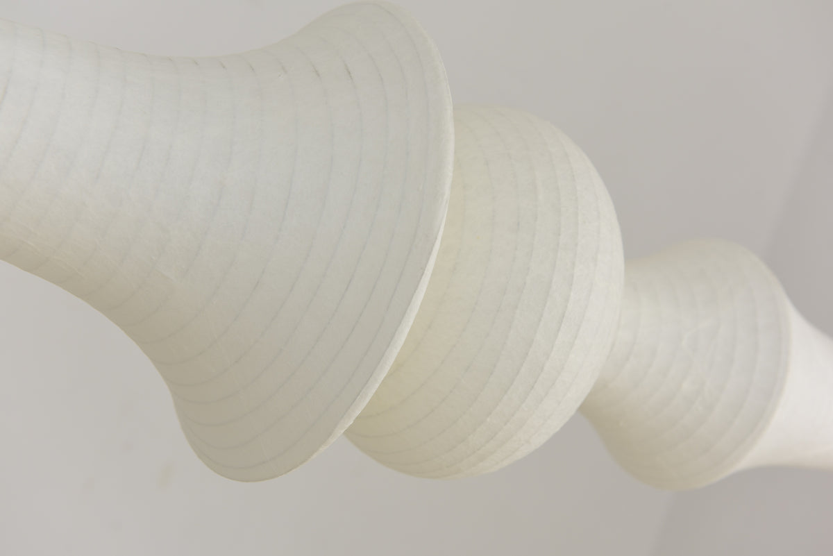 Actual oblique close-up of unlit Orlithane mulberry silk fabric, curved frame ribs and the adjoining globe detail.