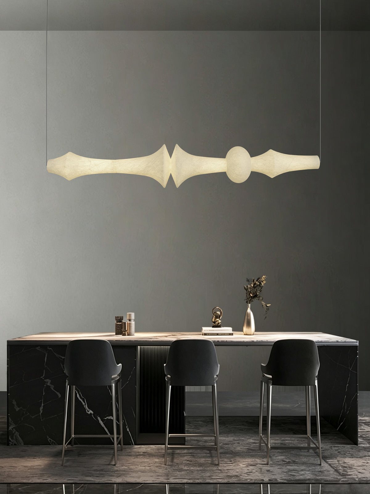 Orlithane linear pendant, Design F, in the original dark stone counter scene with the complete horizontal silk body visible.