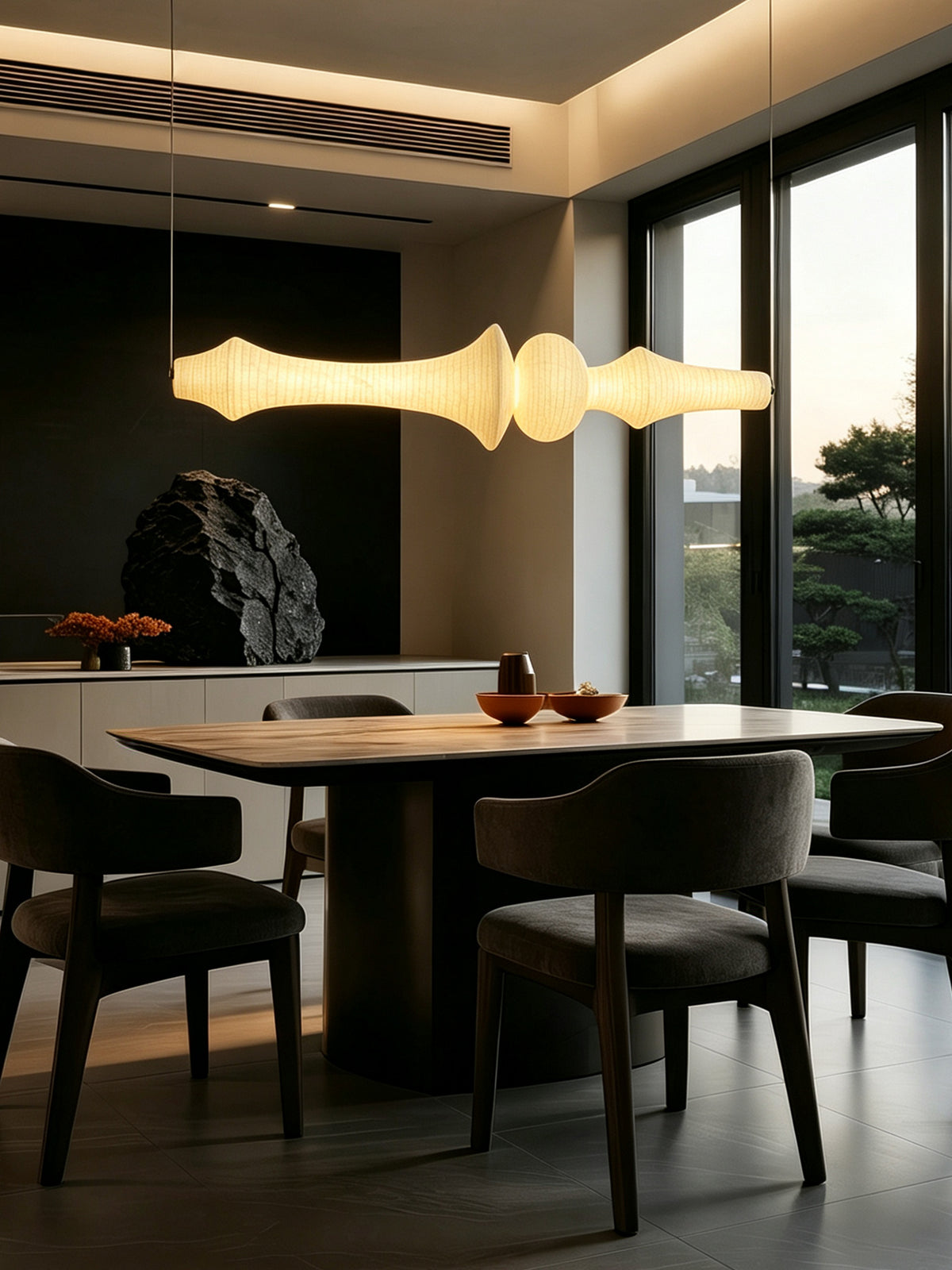 Orlithane linear pendant, Design E, illuminated above a dining table in the original window-side interior scene.