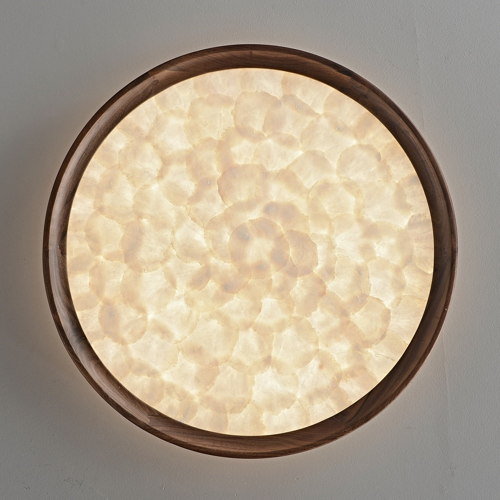Real frontal view of the illuminated shell mosaic face within the walnut wood rim