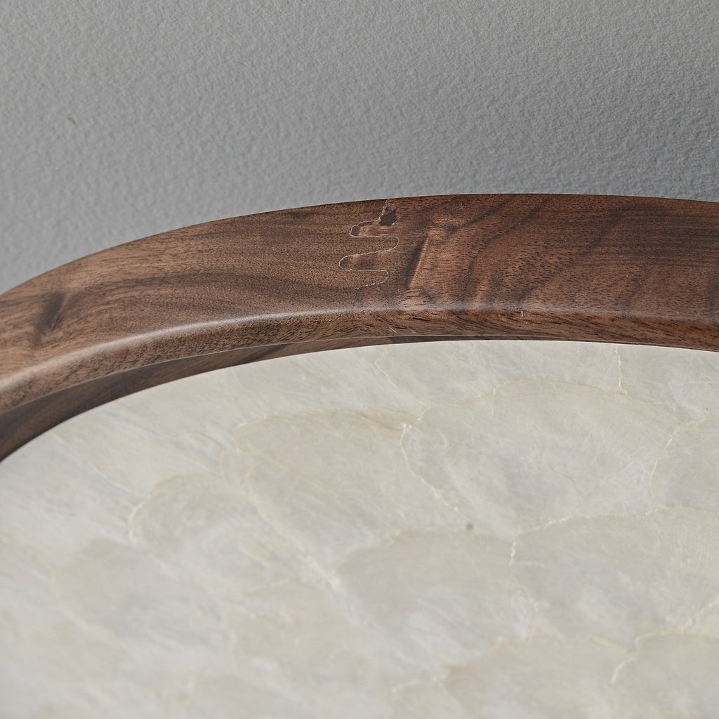 Real close-up of walnut grain, wood join seam and unlit shell diffuser edge