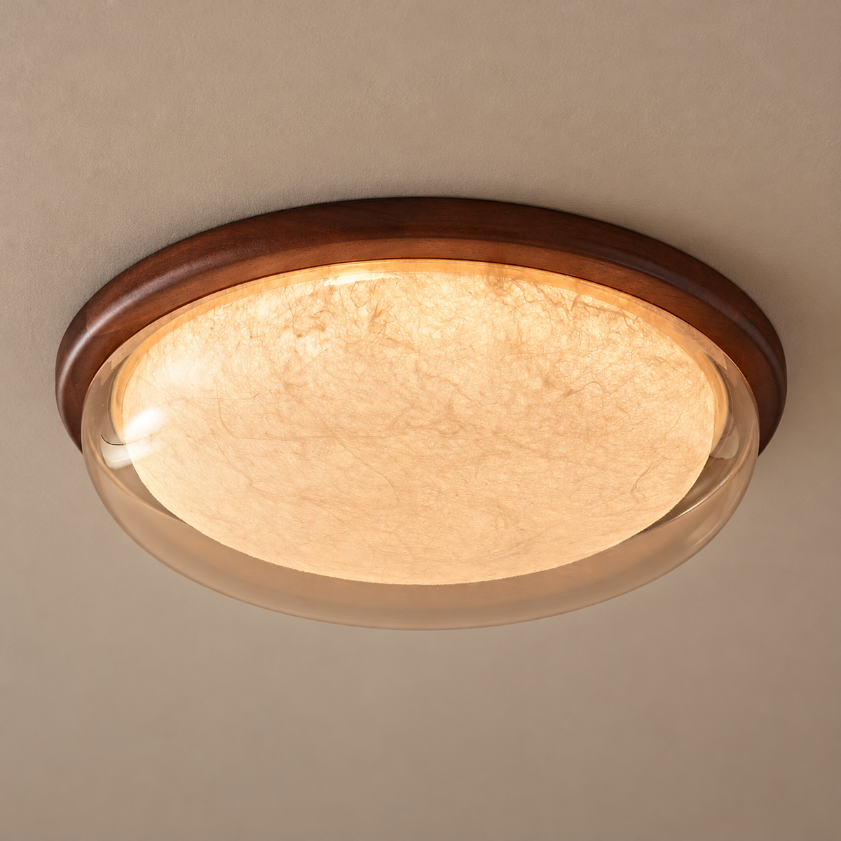 Sapelune Amber silk and sapele wood ceiling light illuminated against a neutral ceiling