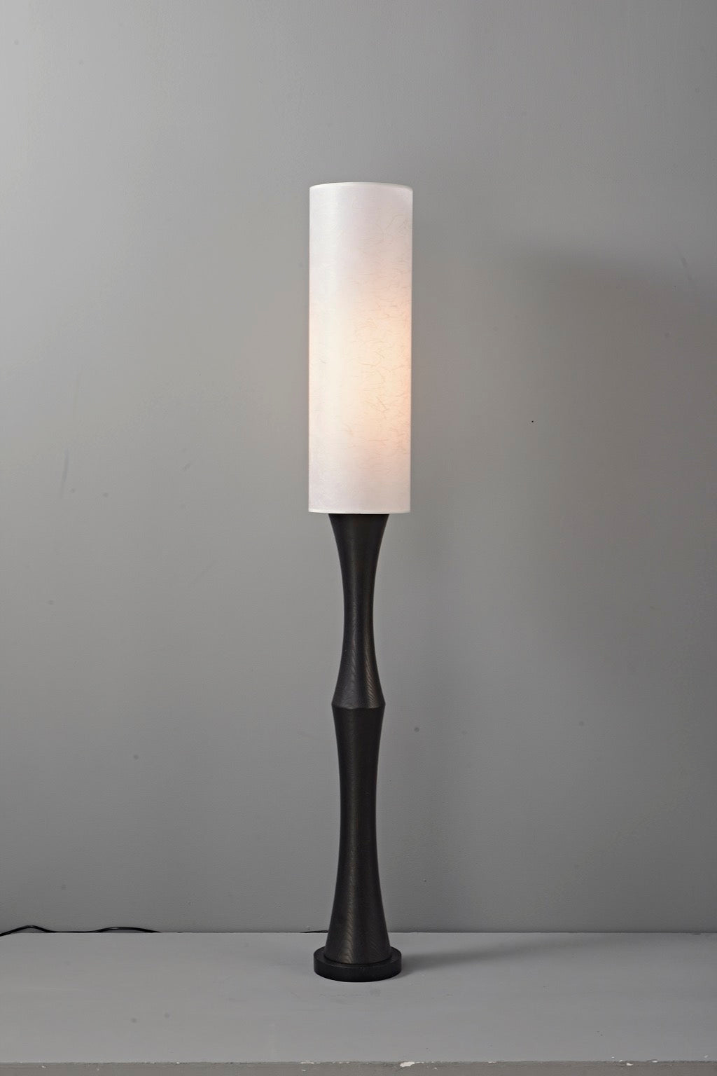 Tavrane black ash wood and fabric floor lamp, overall, light on