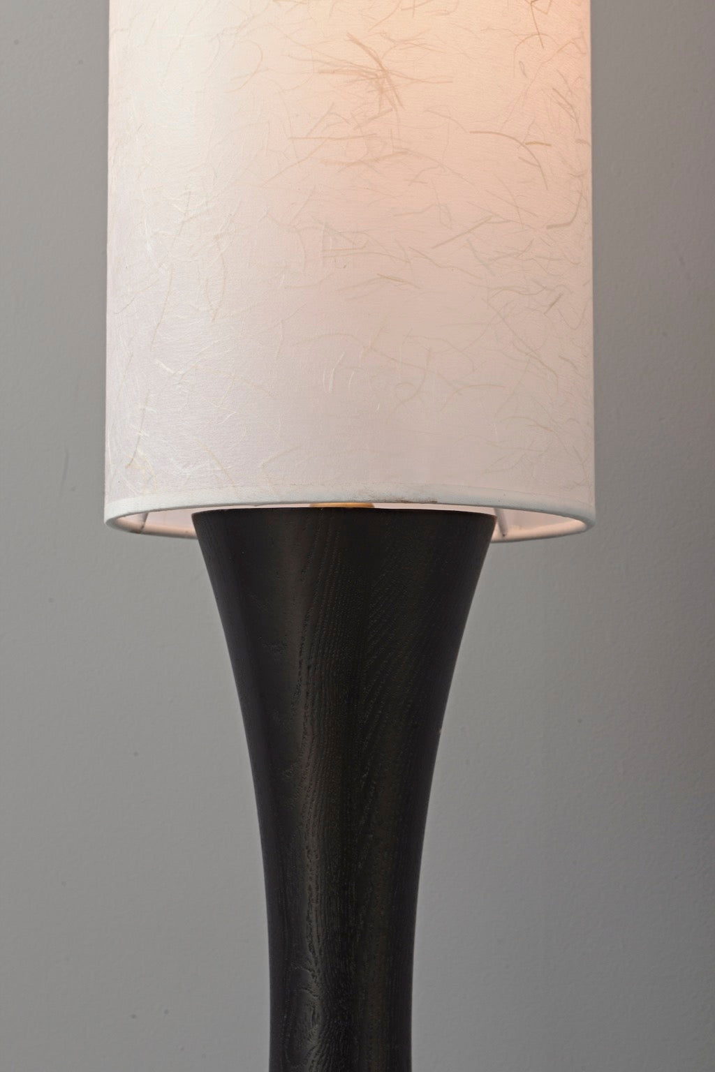 Tavrane black ash wood and fabric floor lamp, detail, light on