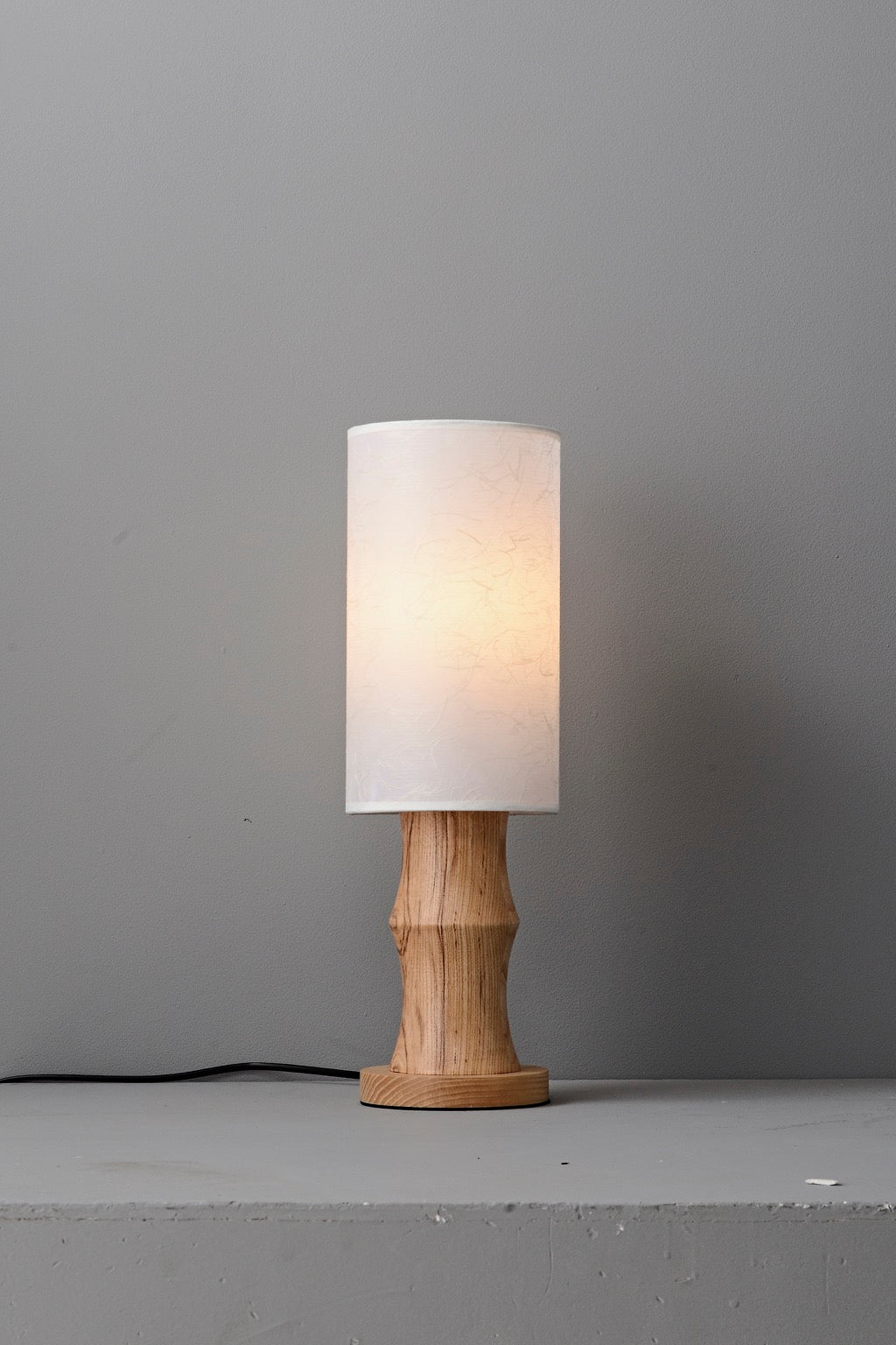 Tavrane natural ash wood and fabric table lamp, overall, light on