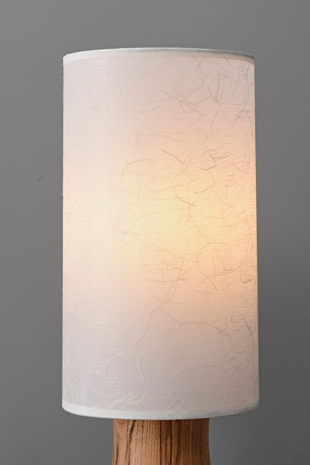 Tavrane natural ash wood and fabric table lamp, detail, light on