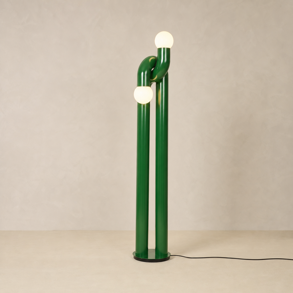 Green Tervilo stainless steel floor lamp with two illuminated glass globes and interlocking curved stems on a warm neutral background