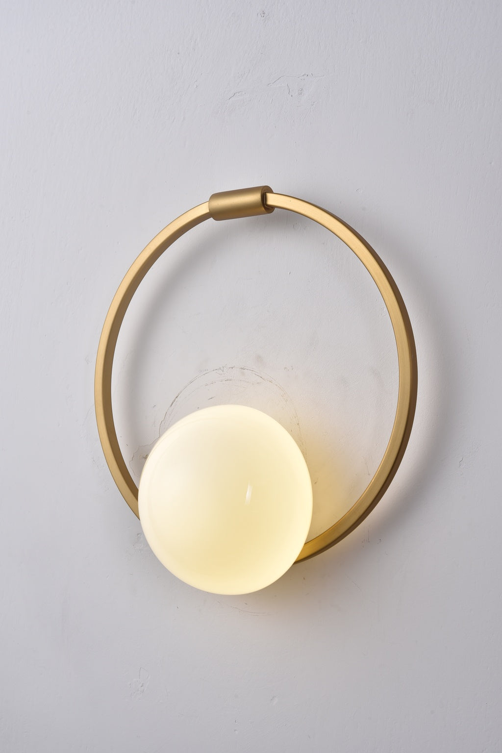 Actual installed Gold circular ring glass wall sconce, turned on