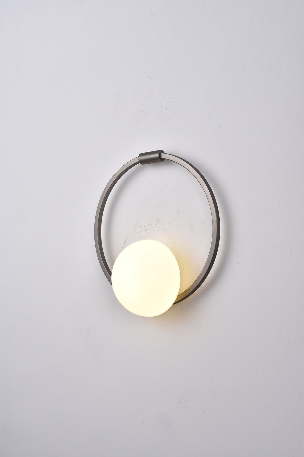 Actual installed Silver circular ring glass wall sconce, turned on