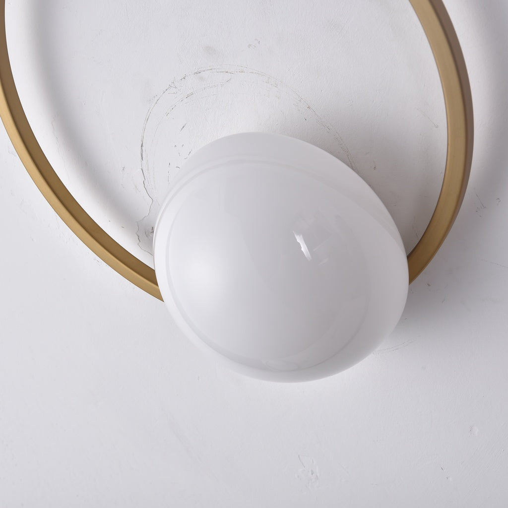 Gold wall sconce glass globe, light off