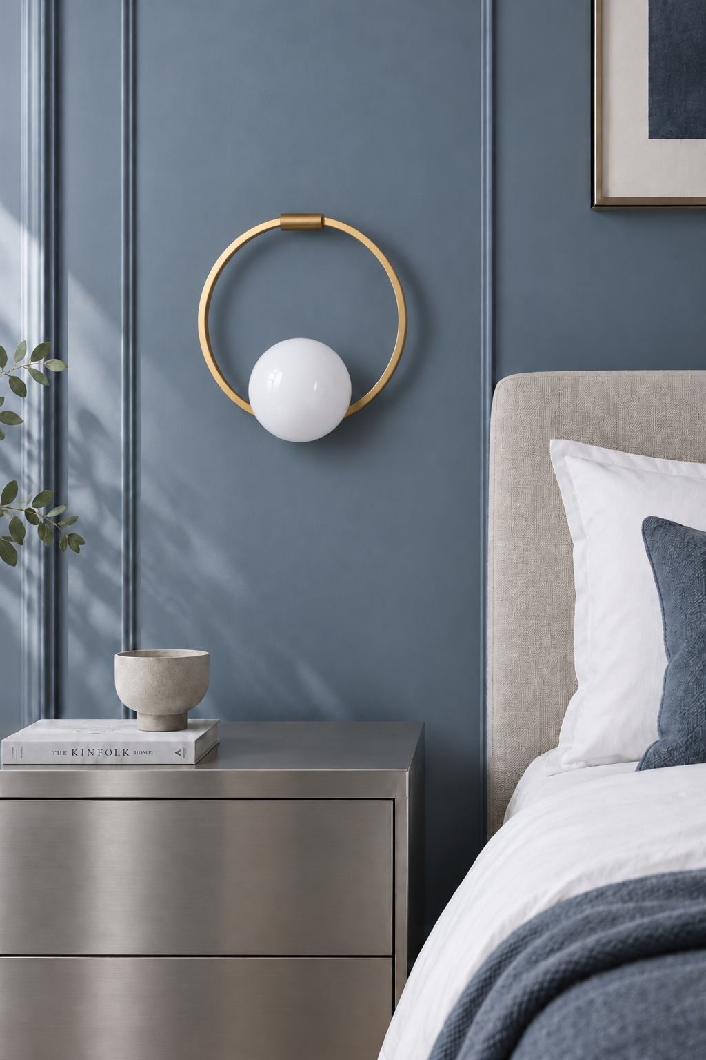 Gold circular ring glass wall sconce seen straight on in a blue bedroom, light off