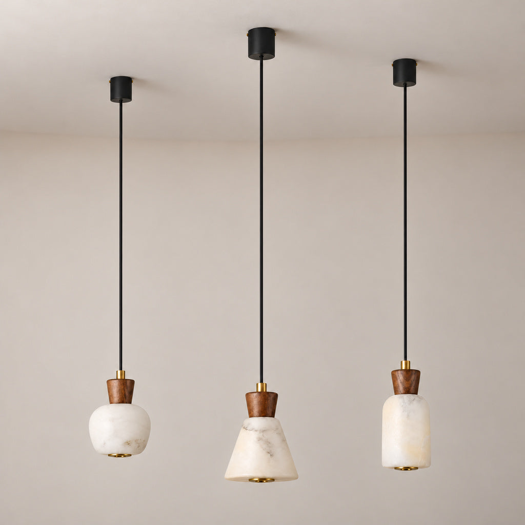 Ashalune alabaster and ash wood mini pendants in rounded, tapered and tall styles, lights off, long black suspension cords