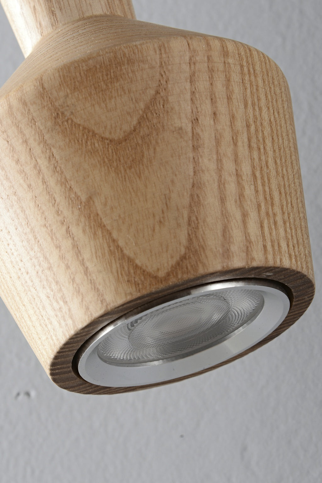 Actual recessed LED lens and metal rim beneath the ash wood lamp head