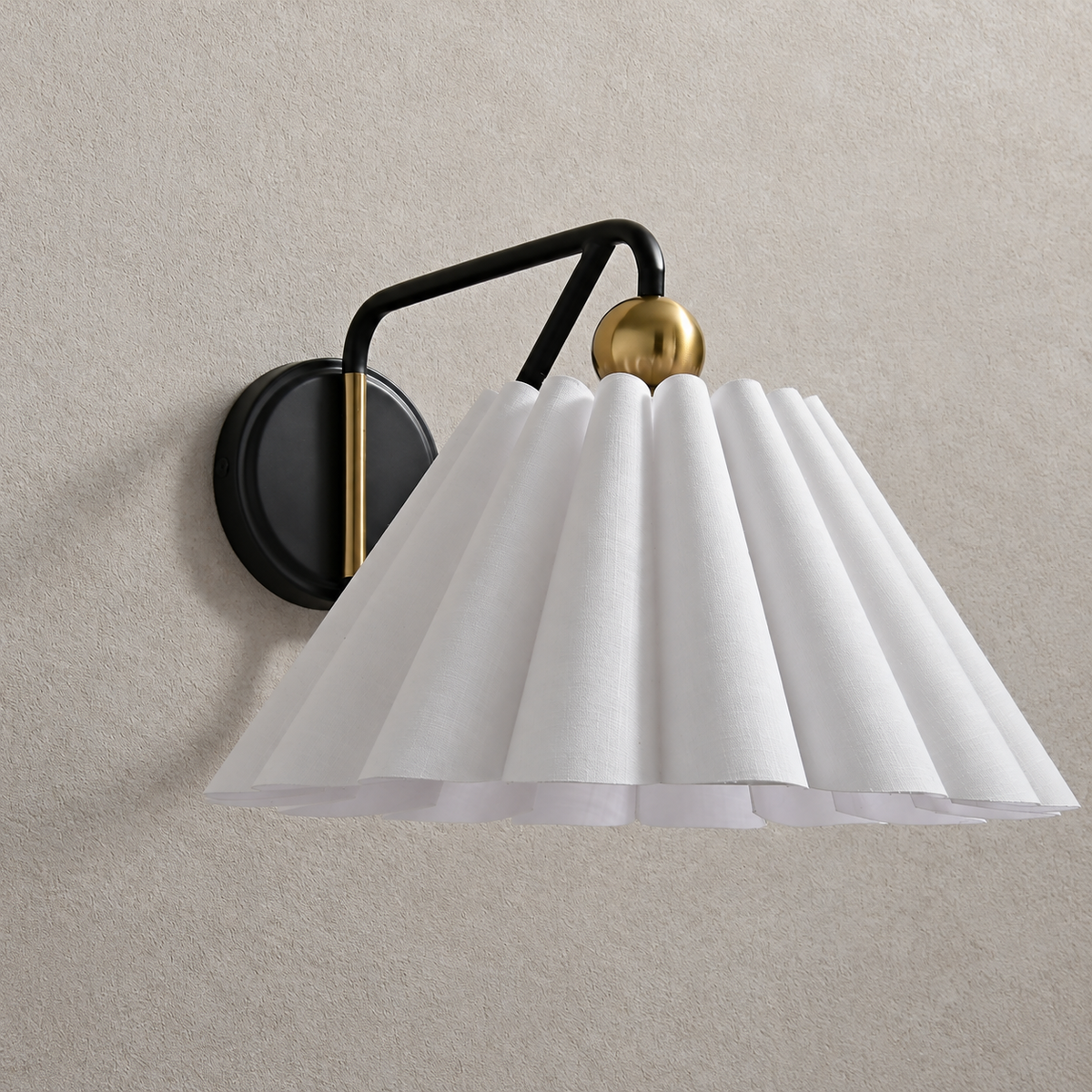 Unlit pleated fabric wall sconce with black triangular arm and brass-tone sphere
