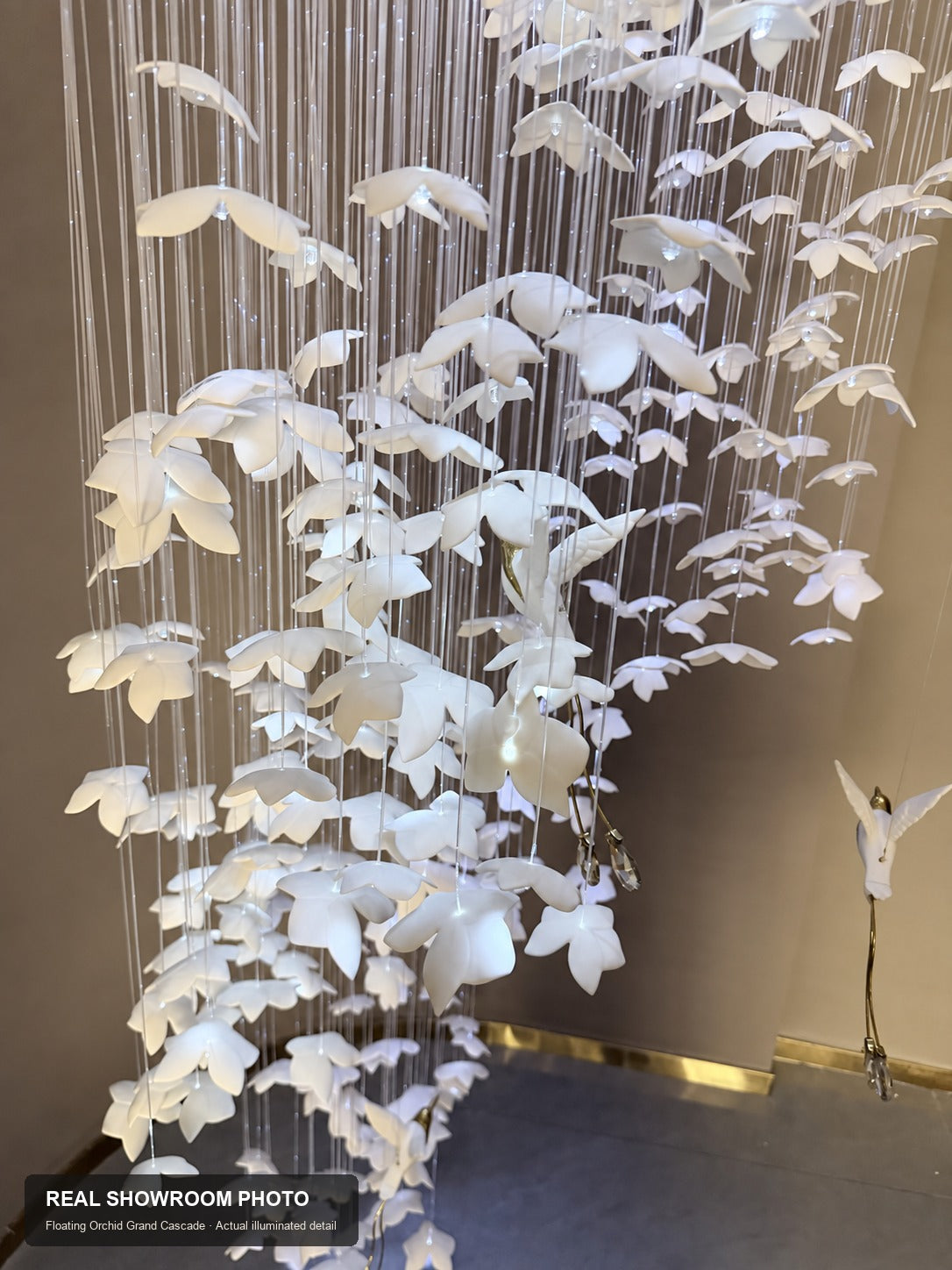 Floating Orchid Ceramic Grand Cascade Chandelier — real showroom photo, mid-range ceramic orchid and suspension detail