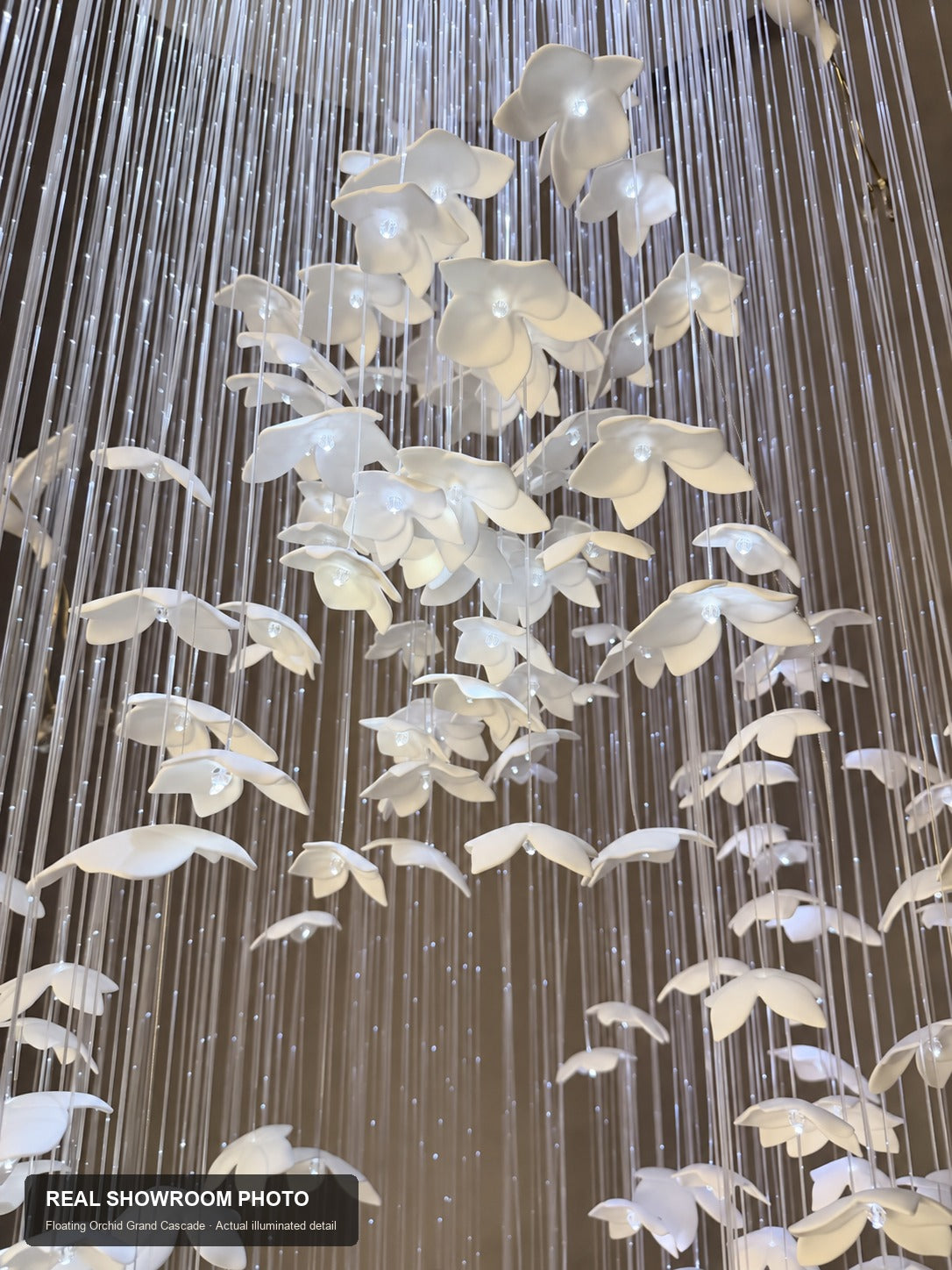 Floating Orchid Ceramic Grand Cascade Chandelier — real showroom photo, illuminated ceramic orchid petal detail