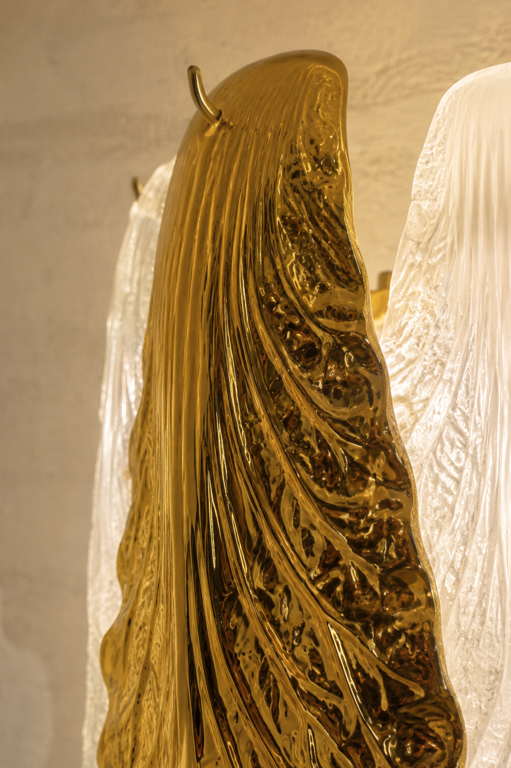 Ceramic and Glass Petal Grand Chandelier: close view of the reflective gold petal