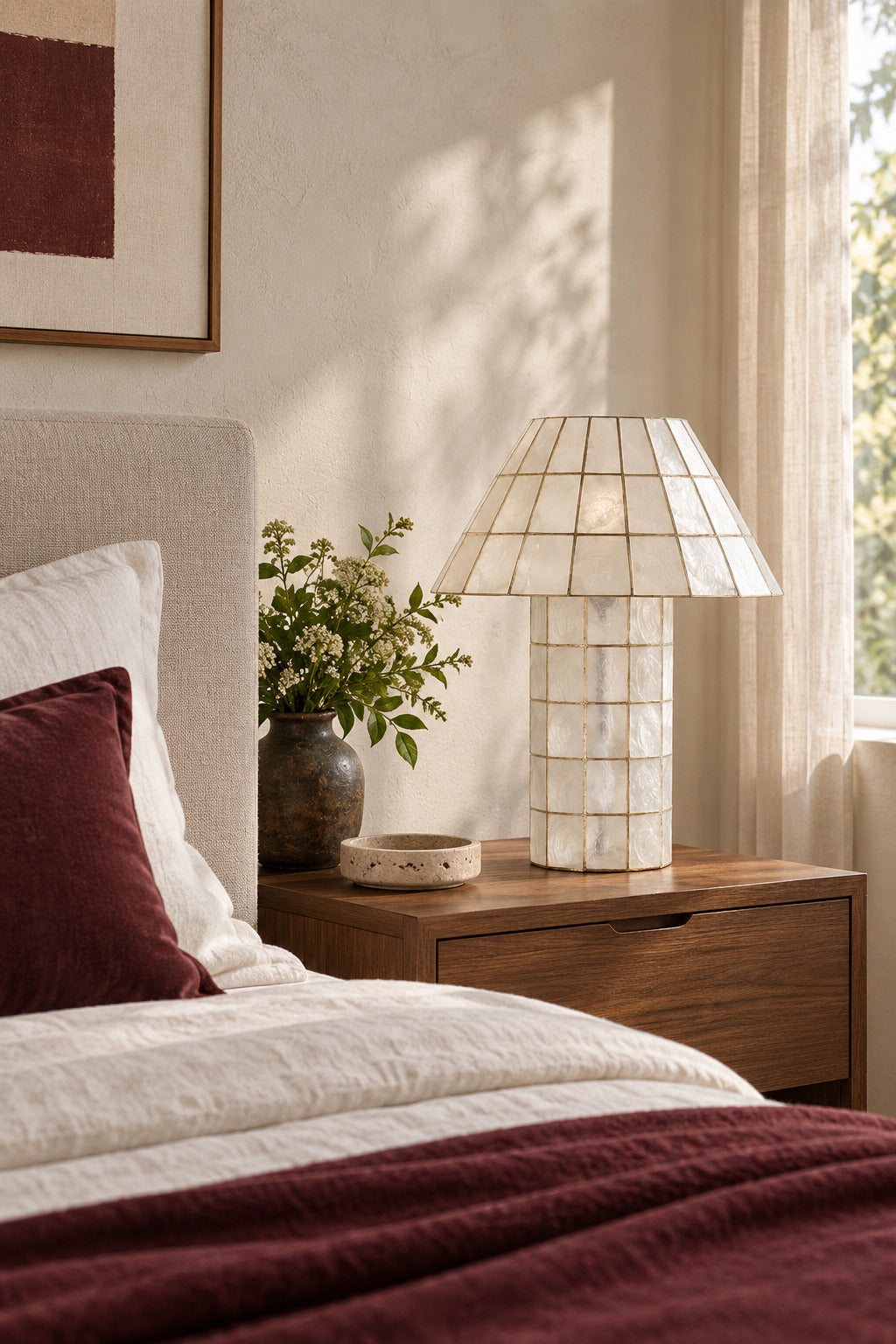 Ivorelle faceted lattice table lamp unlit on a wood bedside table in a bright bedroom