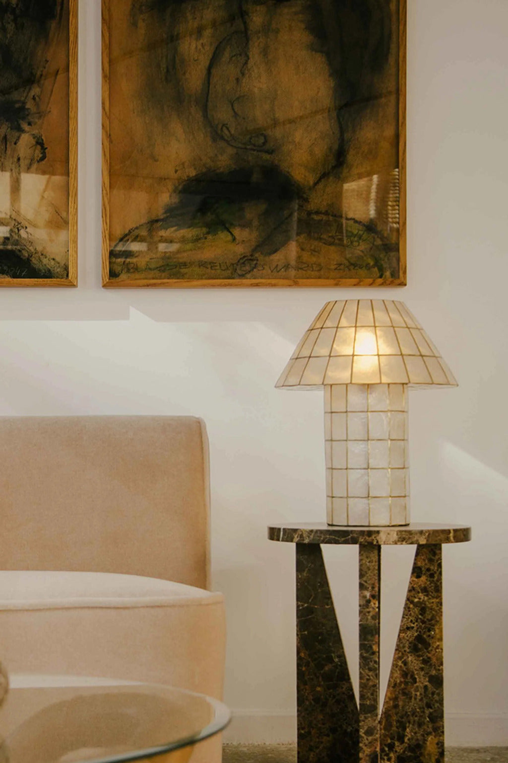 Ivorelle lattice table lamp beside abstract artwork in a modern lounge