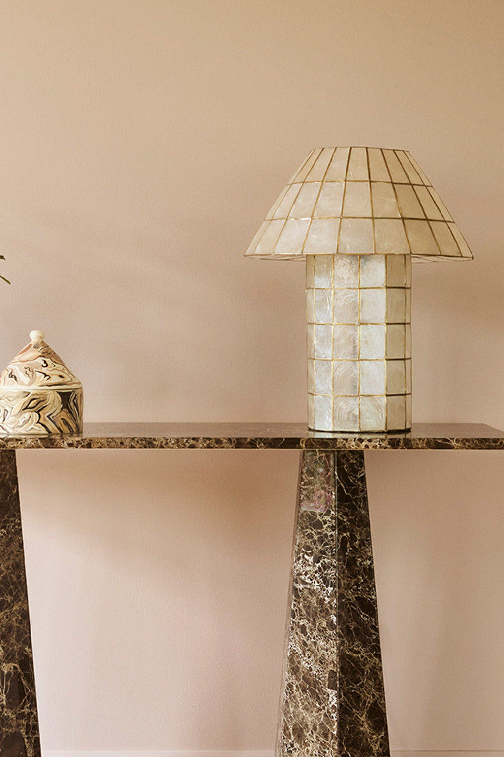 Ivorelle lattice table lamp displayed on a sculptural stone console
