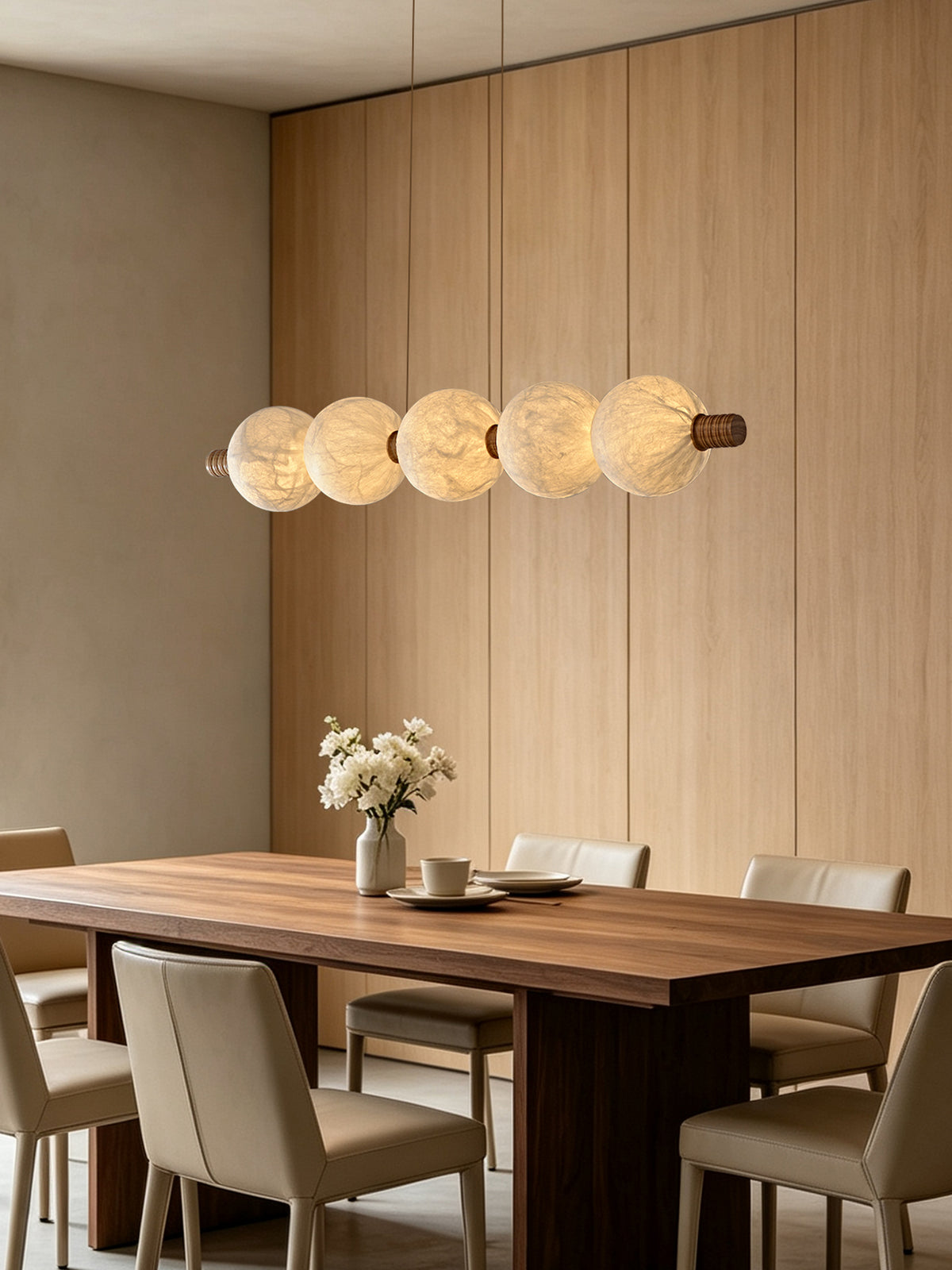Five-globe natural mulberry silk linear pendant with wood details above a dining table