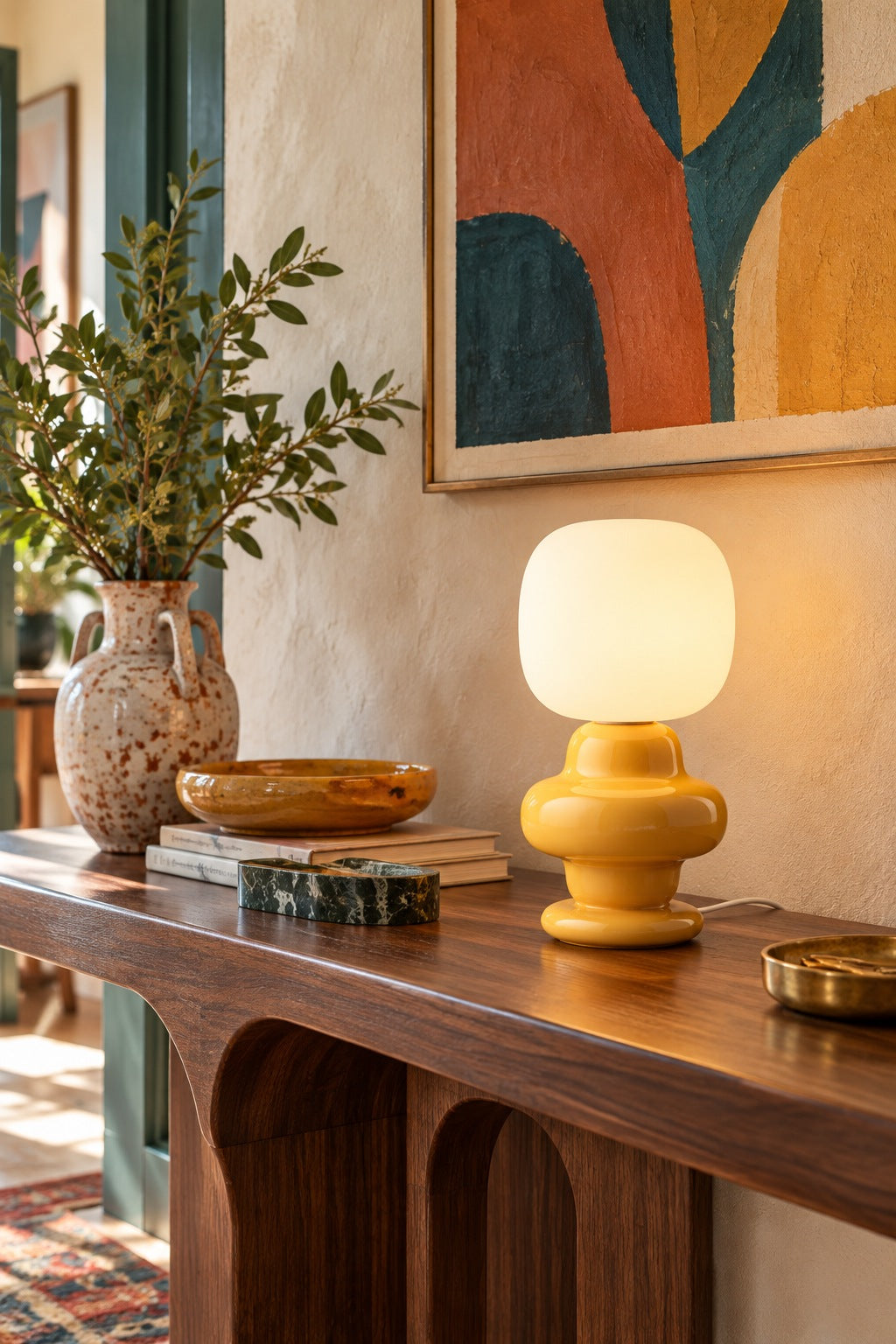 Marunelle yellow table lamp on a sculptural wood console