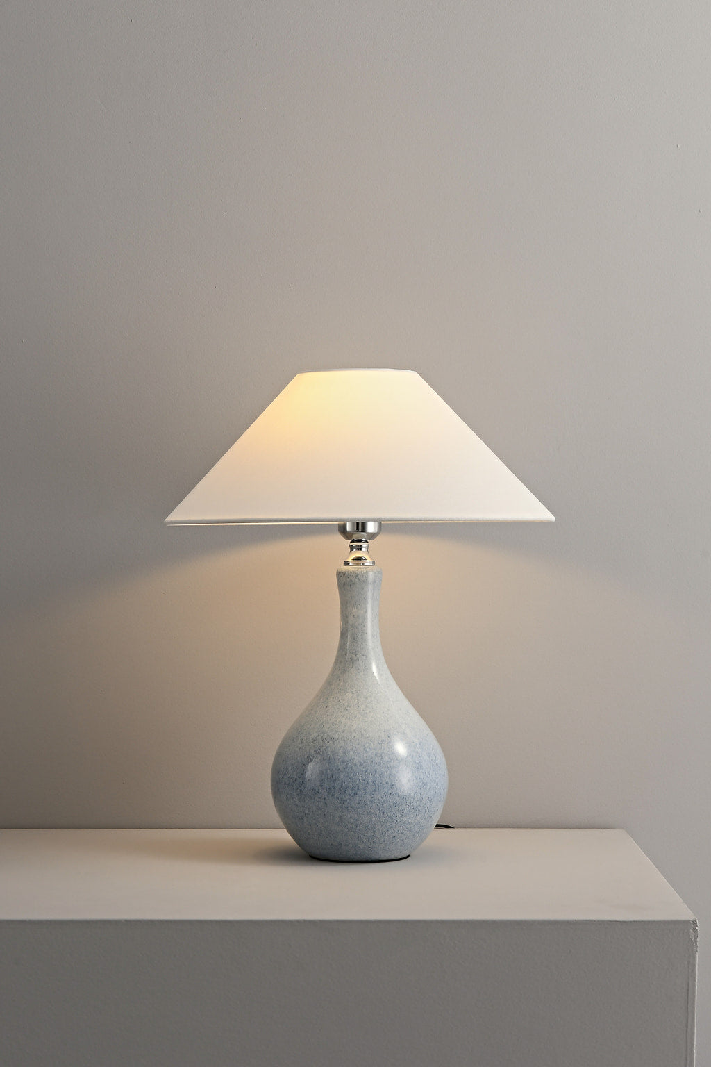 Mist-Blue glazed ceramic table lamp illuminated