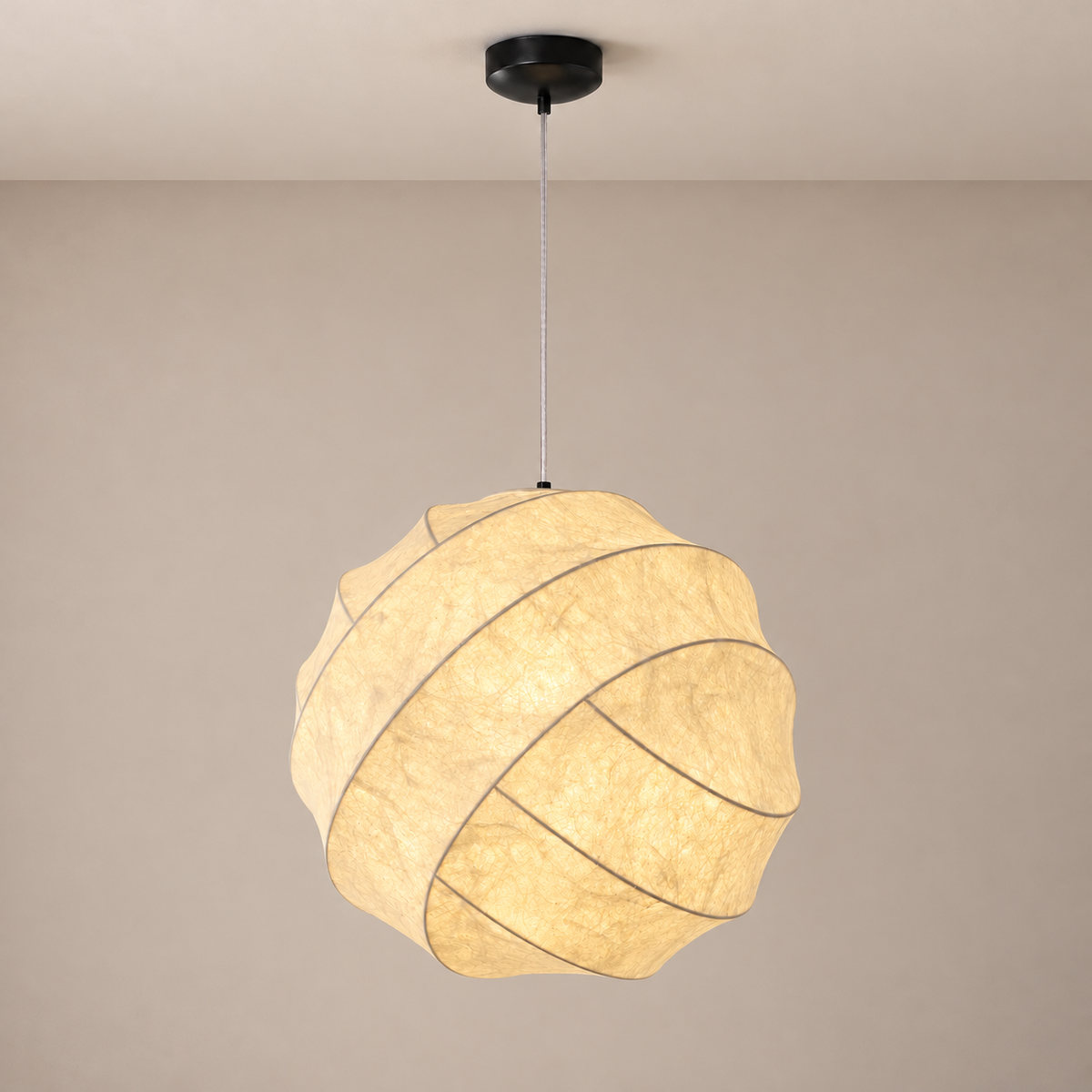 Nuvareth spiral mulberry silk pendant glowing softly below a black ceiling canopy with a long clear suspension cable